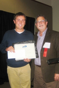 Mark Stafford (right) presents Griffin Donaldson (left) with the “Gary Sharp Memorial Scholarship” 